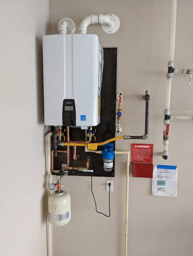 Professional plumber installing copper piping in a Mount Carmel home